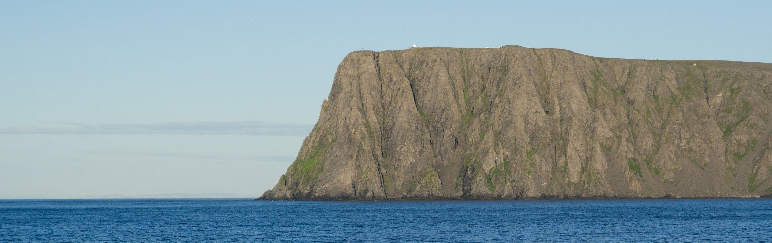 orth Cape with a steep cliff and a large flat plateau is in the Barents Sea.