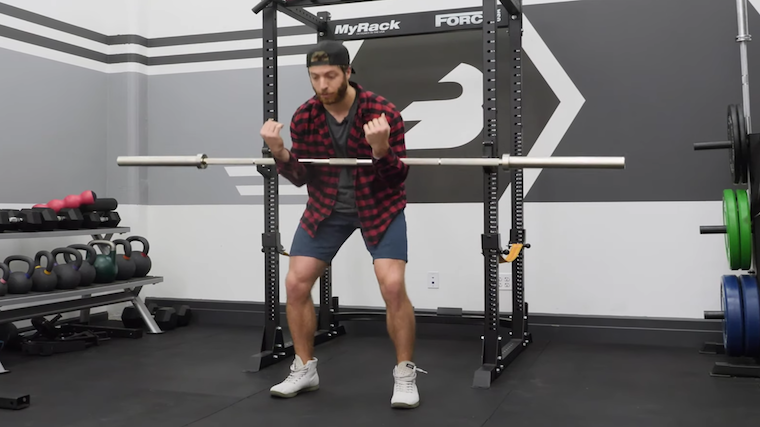 Man performing squat with poor technique