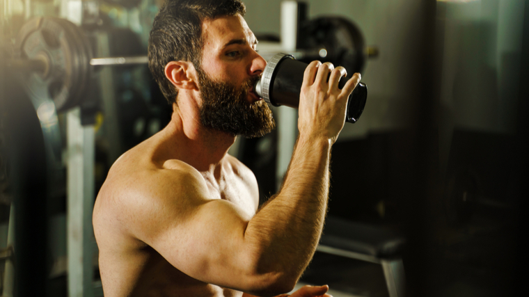 Man drinking protein shake in gym