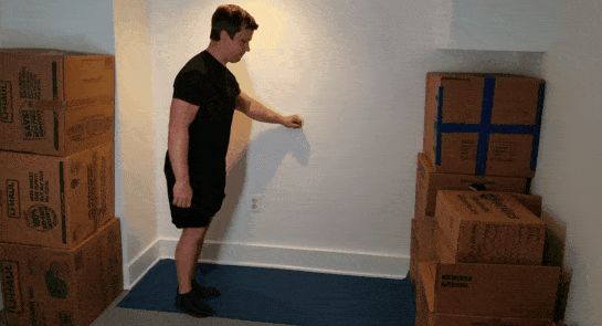 A gif of Coach Jim doing an assisted lunge in a small space.