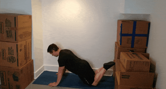 A gif of Coach Jim doing knee push-ups in a small space.