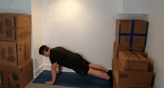 A gif of Coach Jim doing push-ups in a small space.