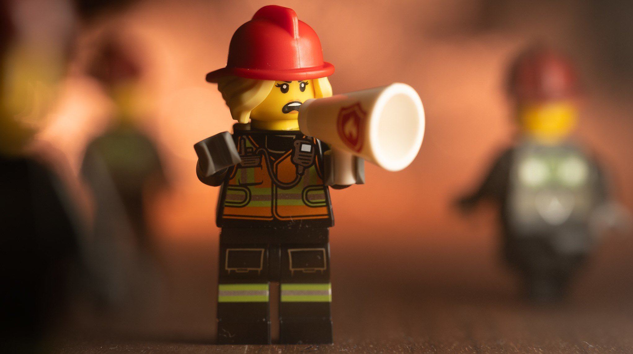 A LEGO Firefighter on a bullhorn.
