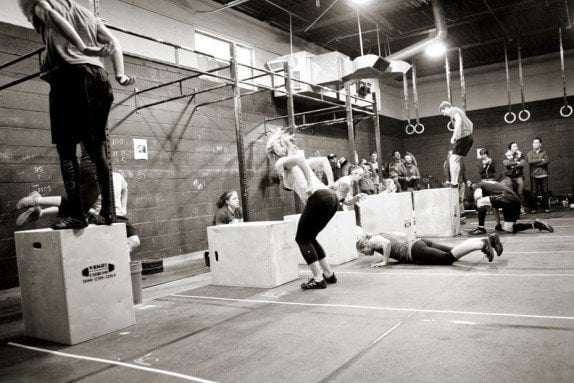 These people are doing box jumps as part of CrossFit.