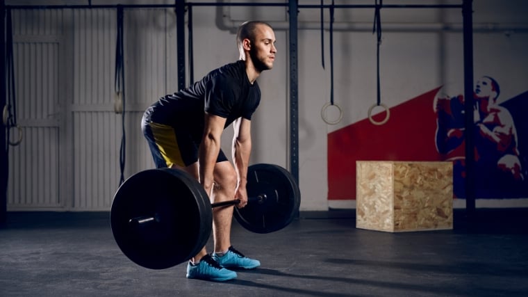 A person doing the first pull in a clean & jerk.