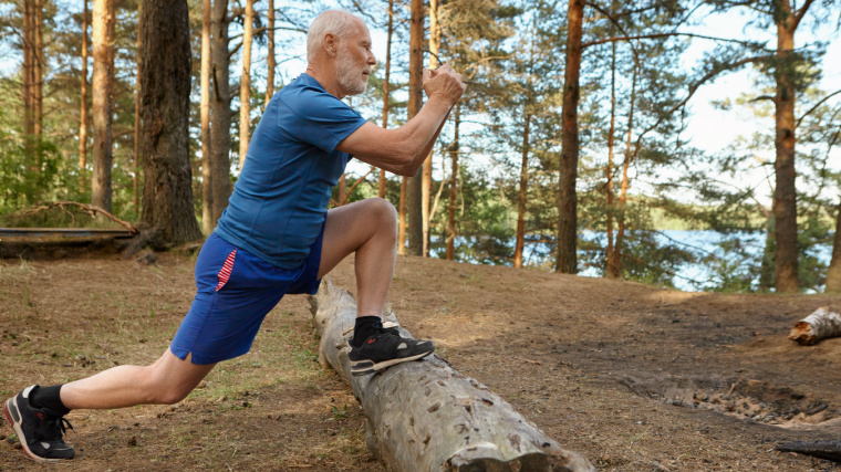 gray-haired person outdoors doing leg exercise