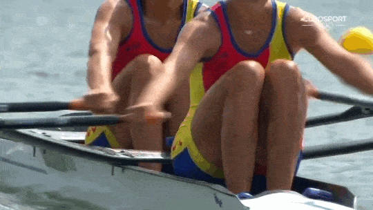 Two people rowing outdoors