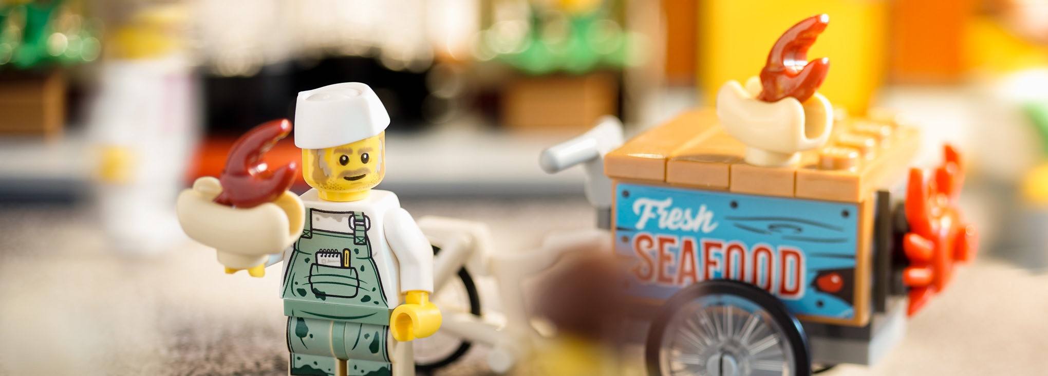 A LEGO holding some seafood, which looks like a big portion size.