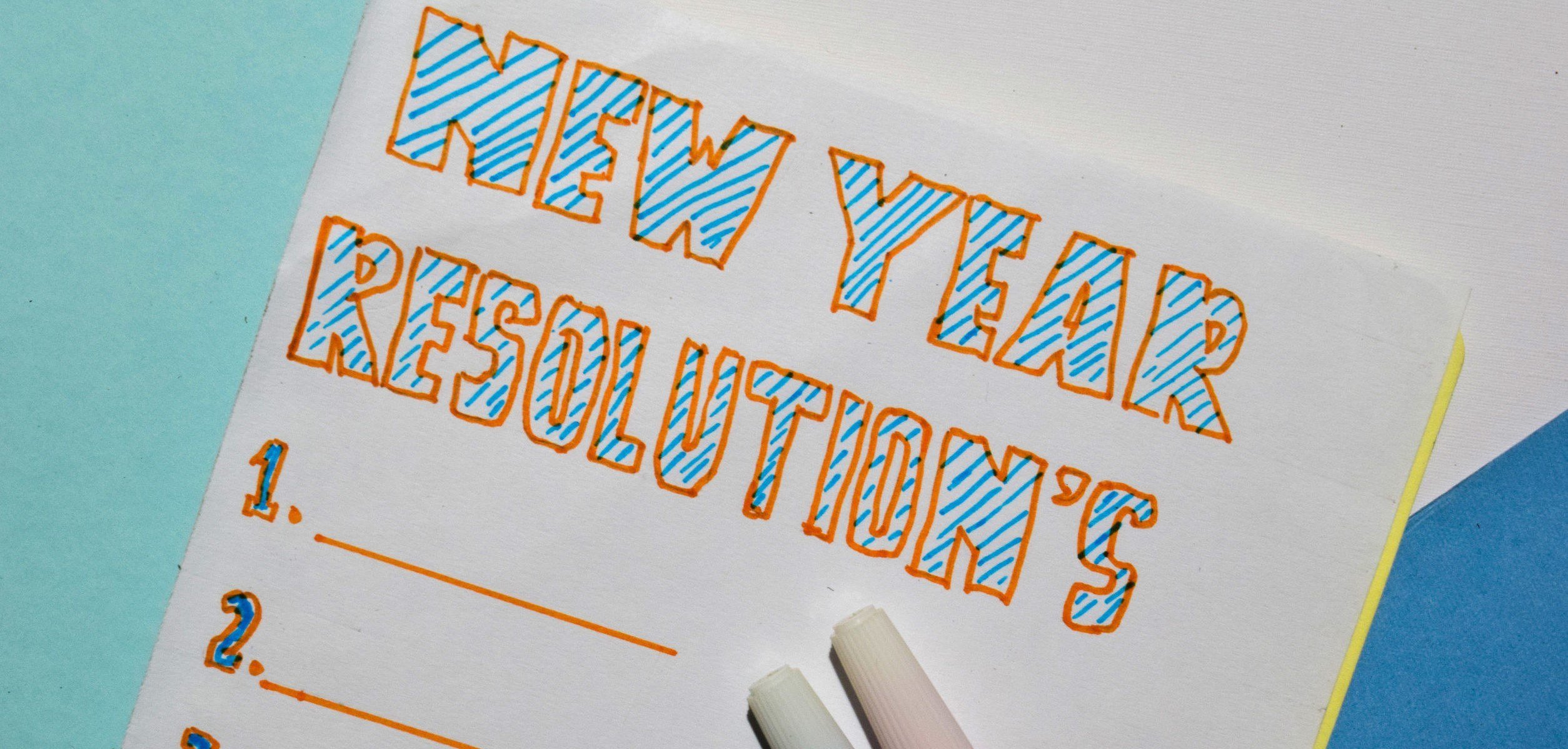 Top view New Year Resolutions text list with marker and eyeglasses for business presentation mock up for adding your list