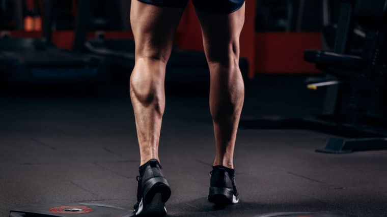 person flexing muscular calves