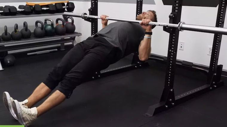 person in gym doing bodyweight row