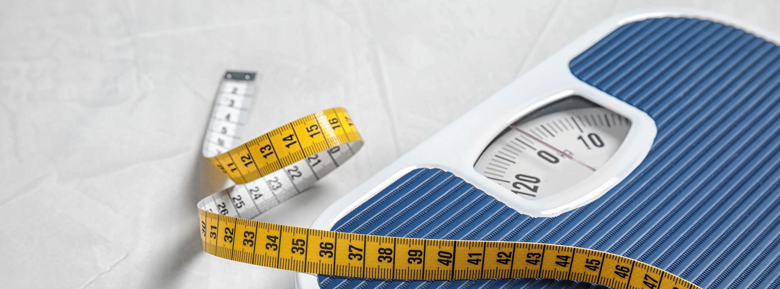 A picture of a scale and tape measure, tools for fast weight loss.