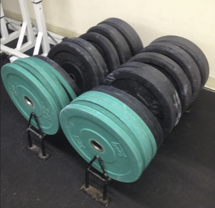 Bumper plates can help you raise your feet for handstand prep.