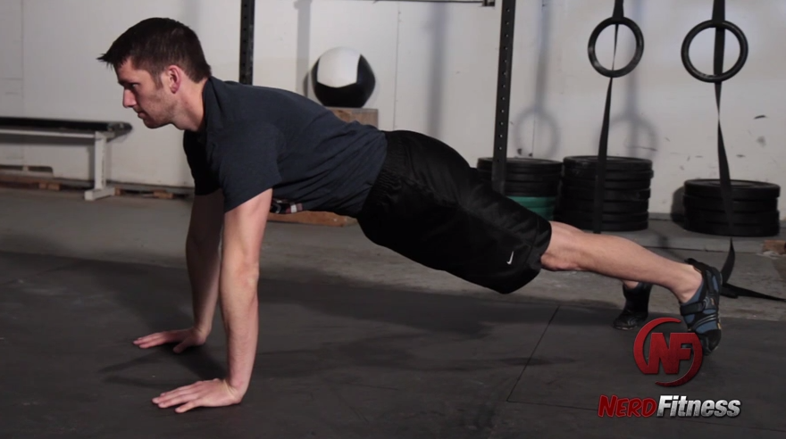 You'll start a wall walk by first getting comfortable in a plank position.