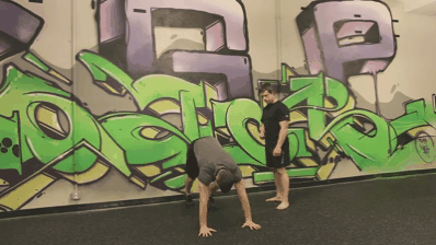 Steve doing a wall walk as part of his handstand progression workout.