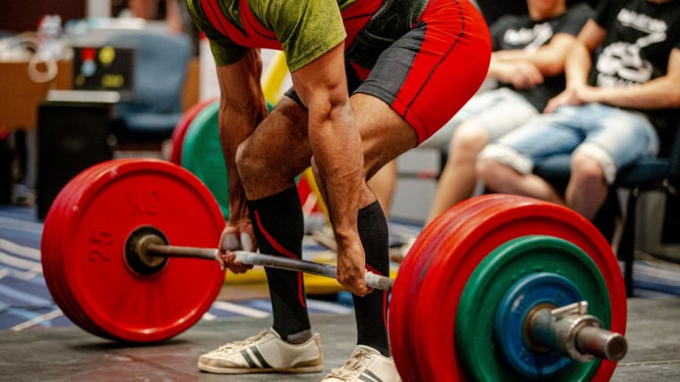Powerlifter performing deadlift in contest